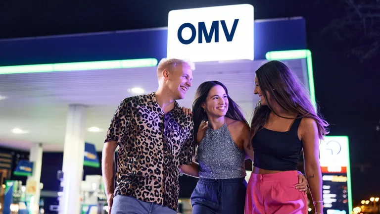 People in front of an OMV station
